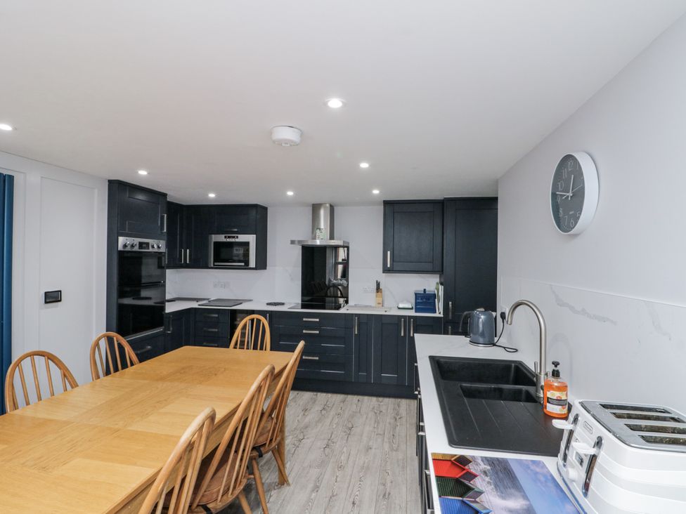 A kitchen with a dining table and appliances at Shelstone in Whitby