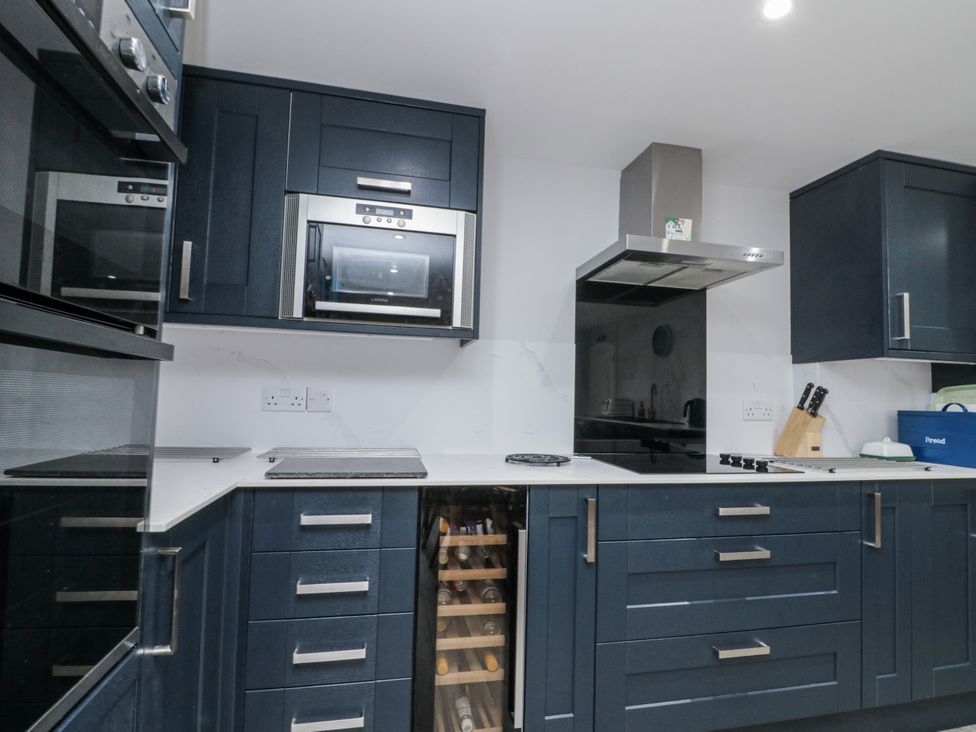 A kitchen with appliances and wine cooler at Shelstone in Whitby