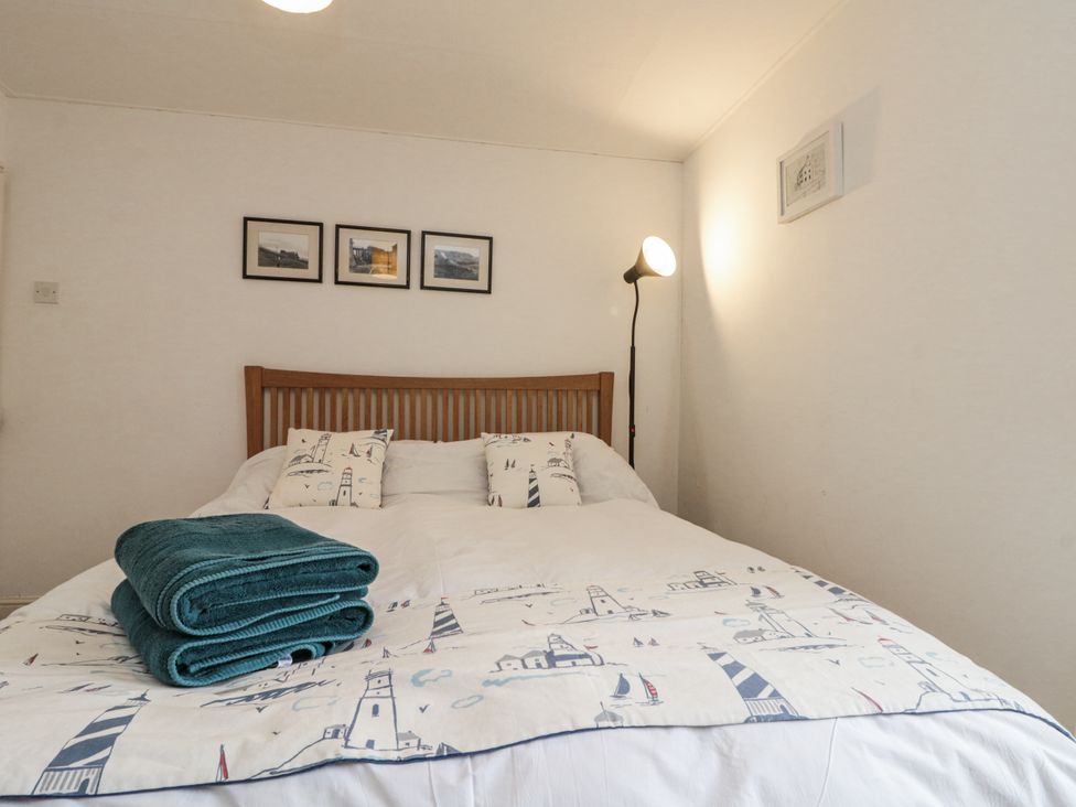 A bedroom with a bed and lamps at Shelstone in Whitby