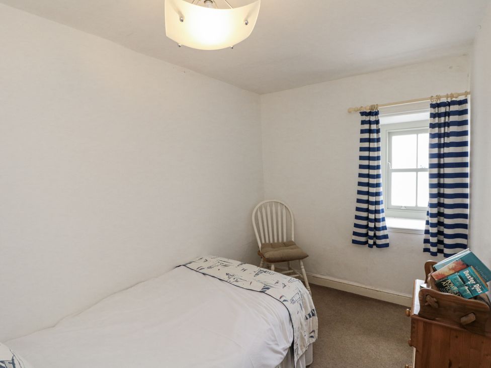 A bedroom with a bed and a chair at Shelstone in Whitby