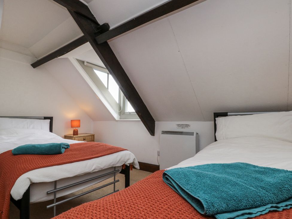 A bedroom with two beds and a window at Shelstone in Whitby
