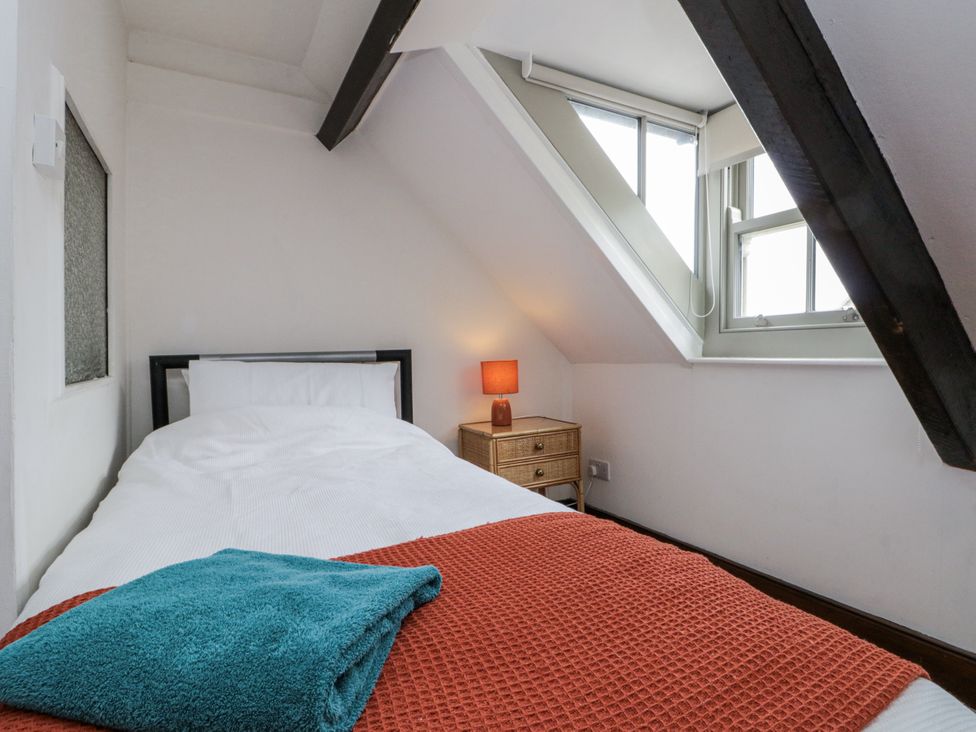 A bedroom with a single bed and bedside table at Shelstone in Whitby