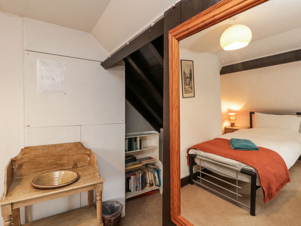 A bedroom with a bed and mirror at Shelstone in Whitby
