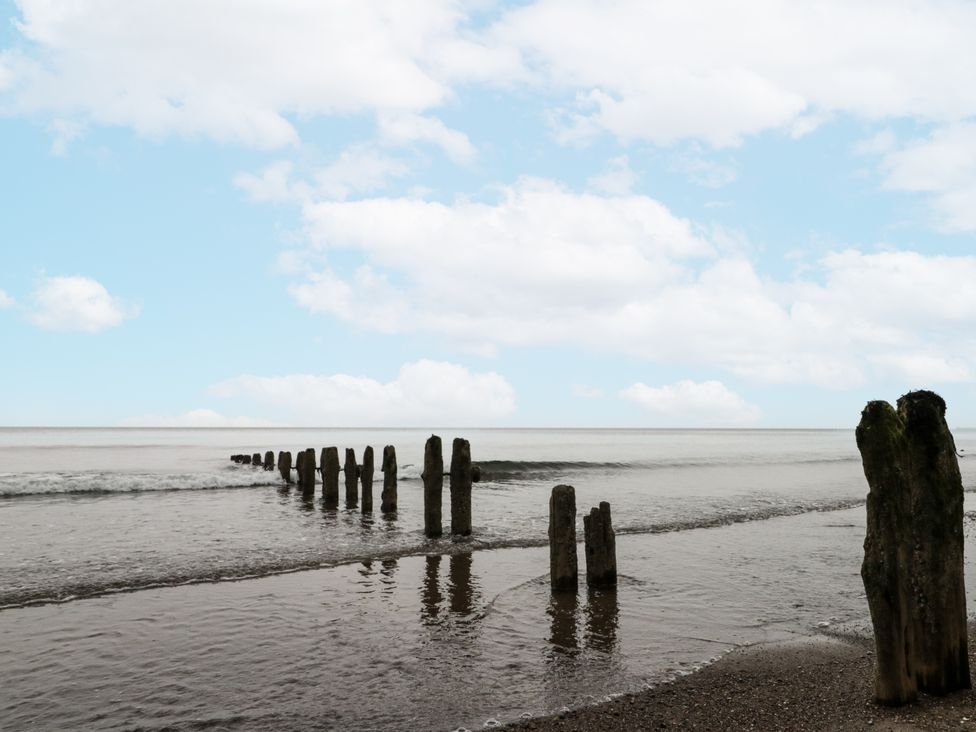 A view of wooden posts extending into the sea at Shelstone in Whitby