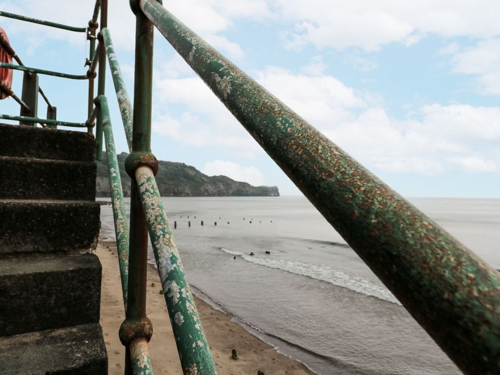 A staircase near the ocean with a railing and clouds at Shelstone in Whitby