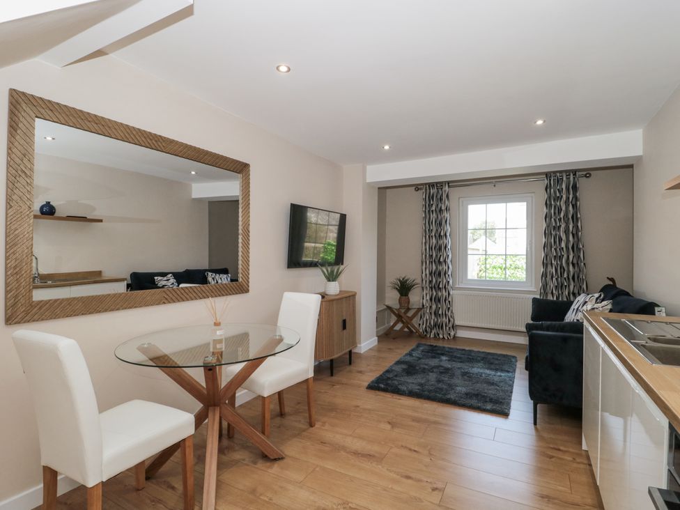 A living room with a table and chairs at Royal Terrace Sunset Weymouth