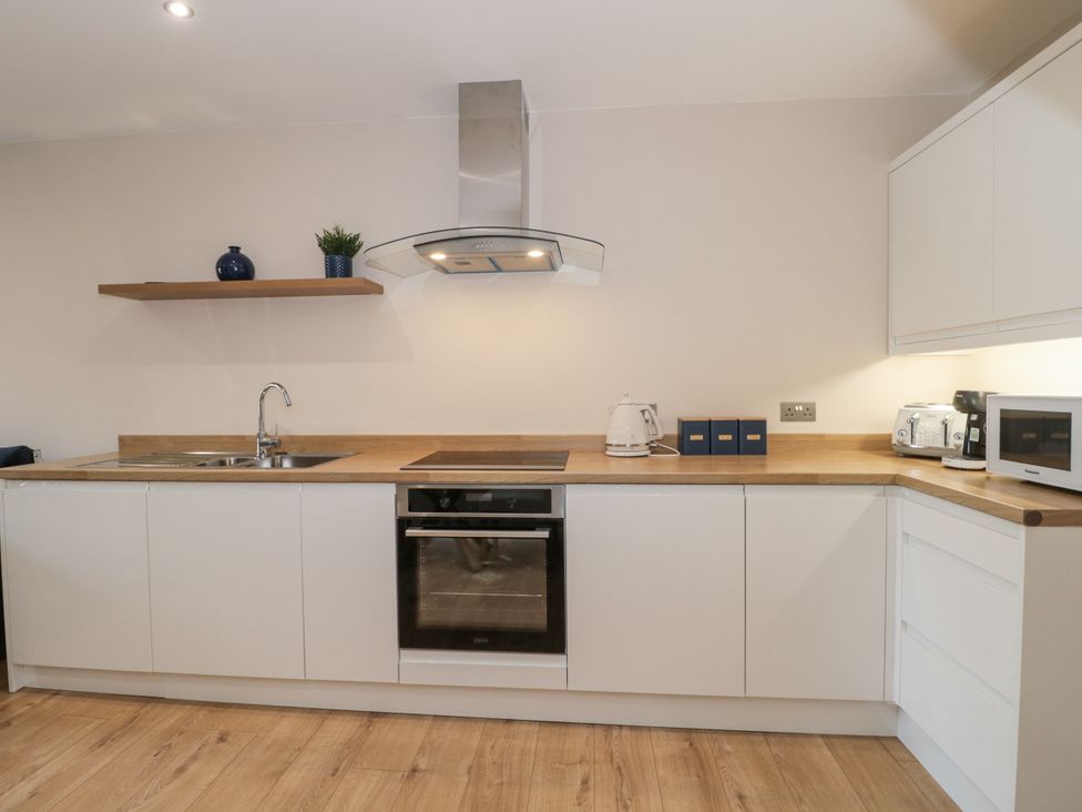 A kitchen with appliances and counter space at Royal Terrace Sunset in Weymouth