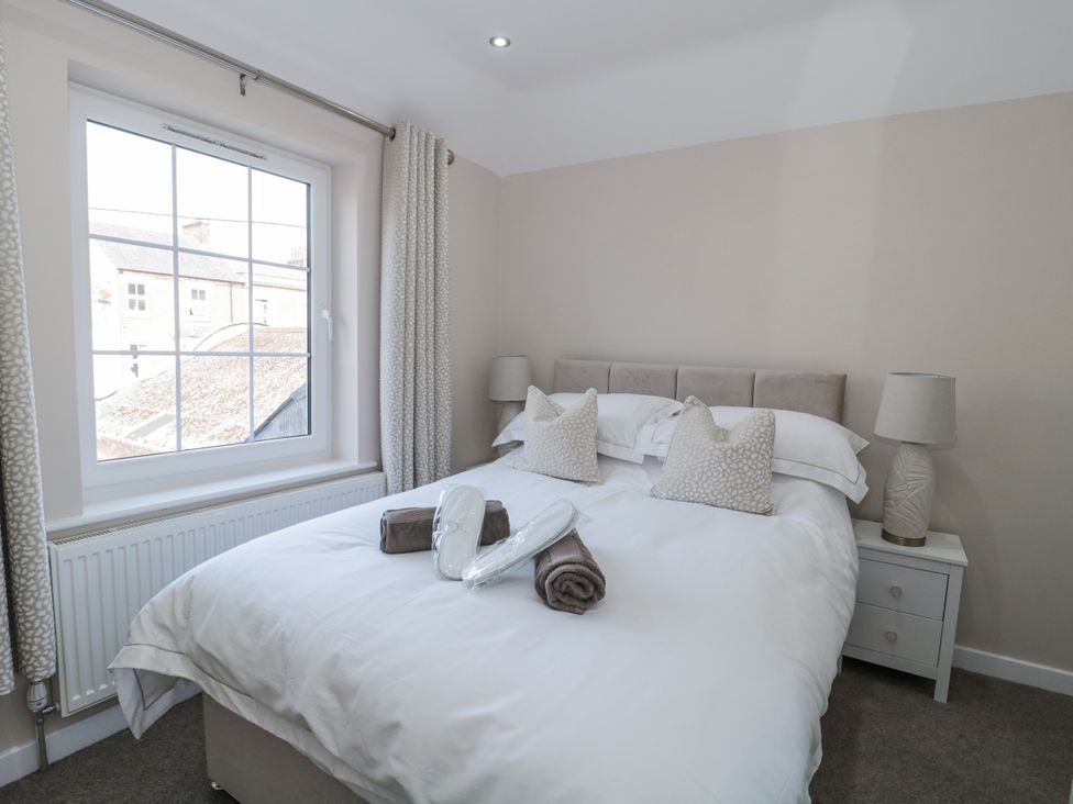 A bedroom with a double bed and window at Royal Terrace Sunset in Weymouth