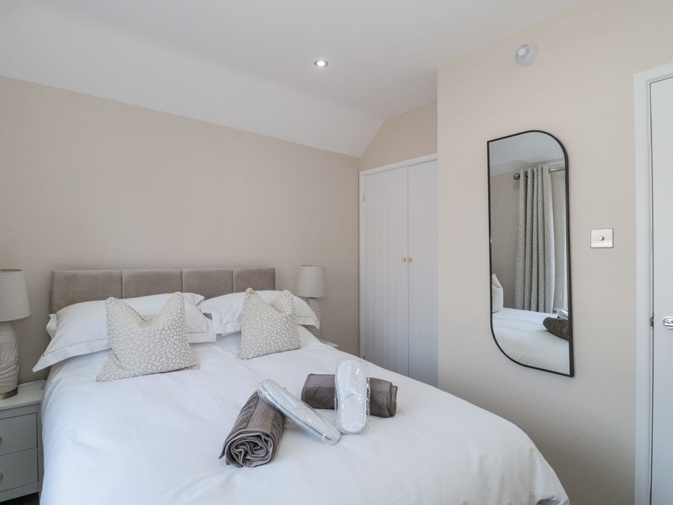 A bedroom with a bed and towels at Royal Terrace Sunset in Weymouth