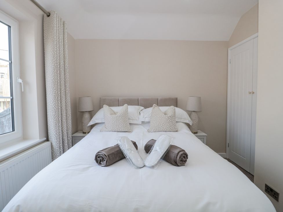 A bedroom with a bed and pillows at Royal Terrace Sunset in Weymouth