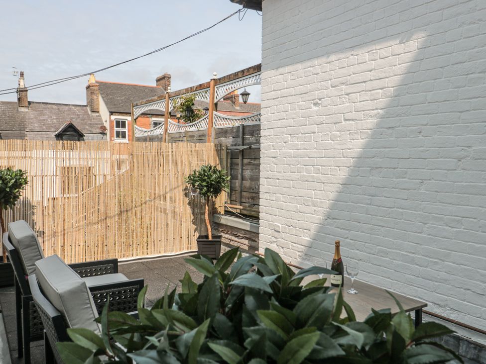 An outdoor space with a table and chairs at Royal Terrace Sunset in Weymouth