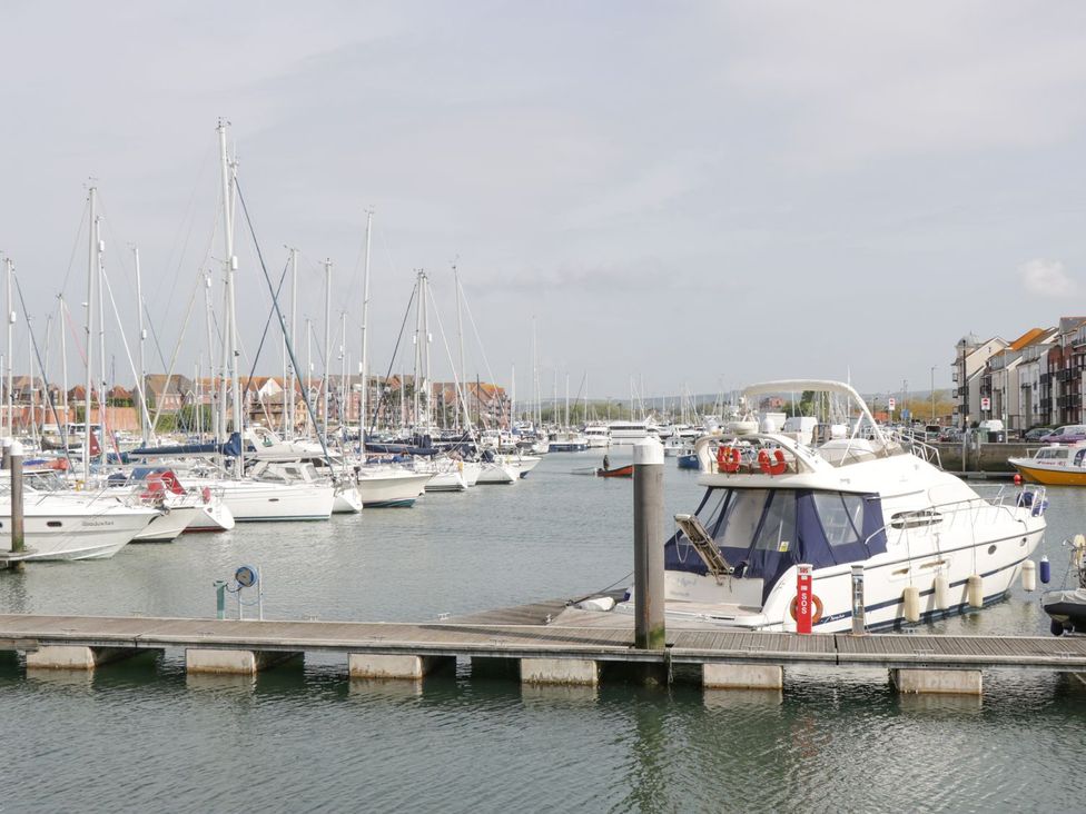 A marina with several boats moored at Royal Terrace Sunset in Weymouth