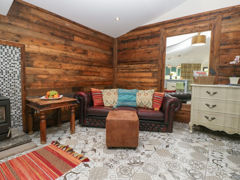 A living room with a sofa and coffee table at Lilac Cottage in Grange-Over-Sands
