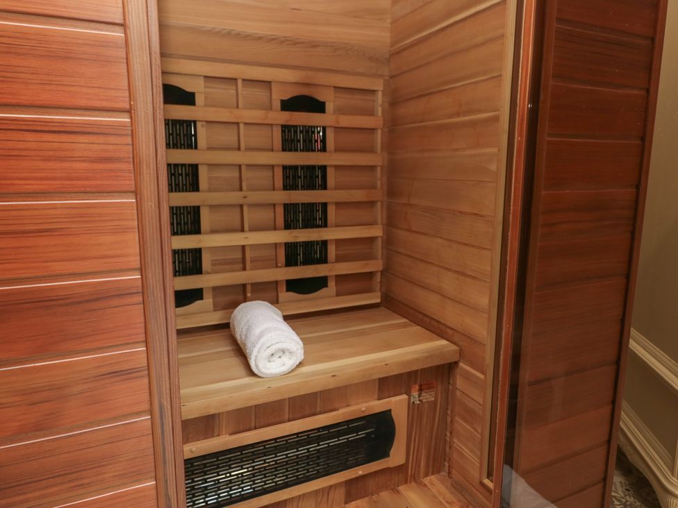 A sauna with wooden paneling and a towel at Lilac Cottage in Grange-Over-Sands