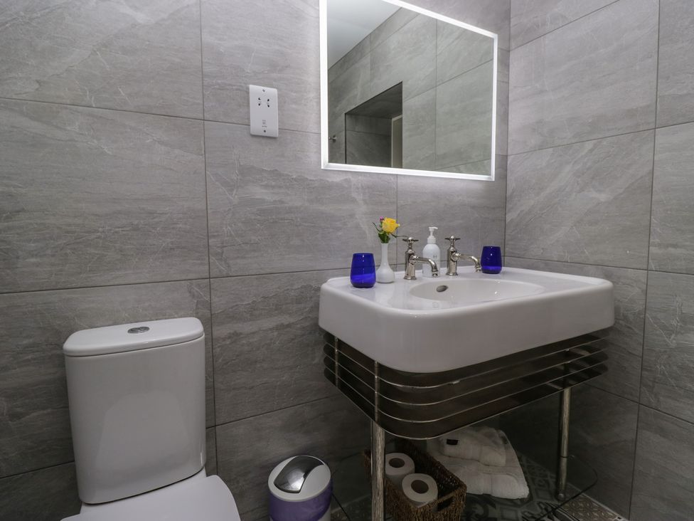 A bathroom with a sink and toilet at Lilac Cottage in Grange-Over-Sands
