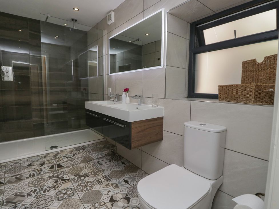 A bathroom with a shower and sink at Lilac Cottage in Grange-Over-Sands