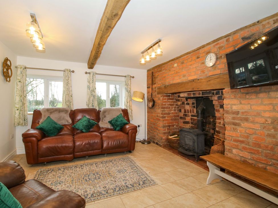 A living room with a sofa and fireplace at 1 Dingle Cottage Worcester