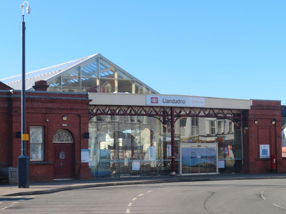 A building exterior with glass structure and signage at Fox House in Llandudno