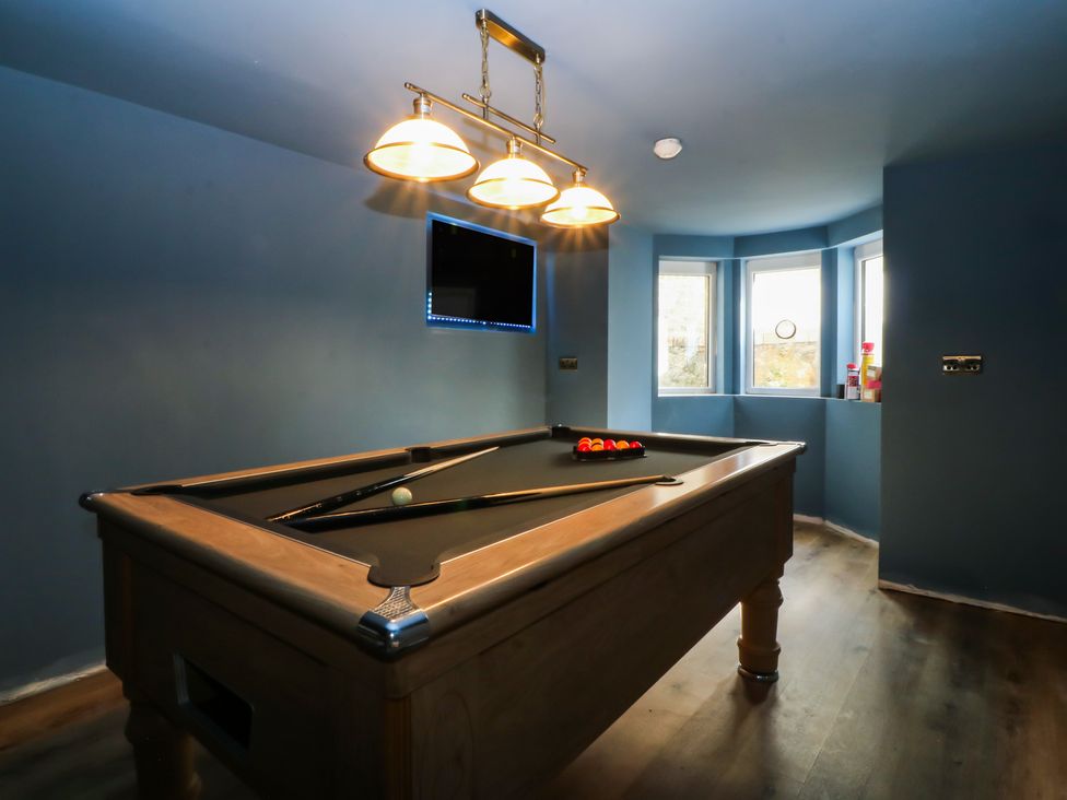 A game room with a pool table and television at Fox House in Llandudno