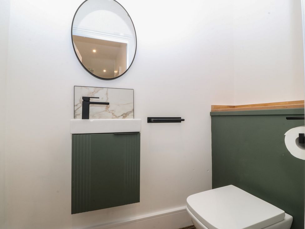 A bathroom with a sink and toilet at Fox House in Llandudno