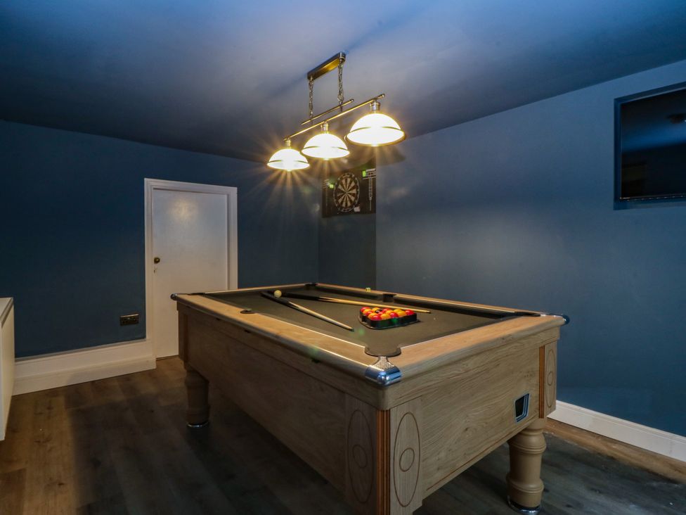 A games room featuring a pool table and dartboard at Fox House in Llandudno