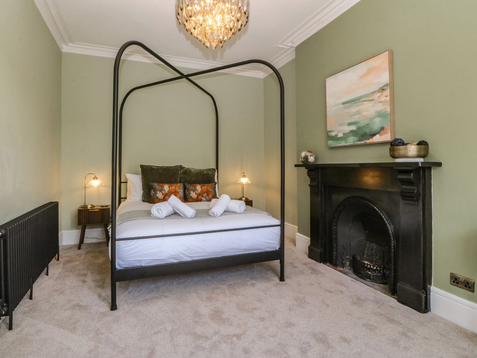 A bedroom with a bed and bedside table at Fox House in Llandudno