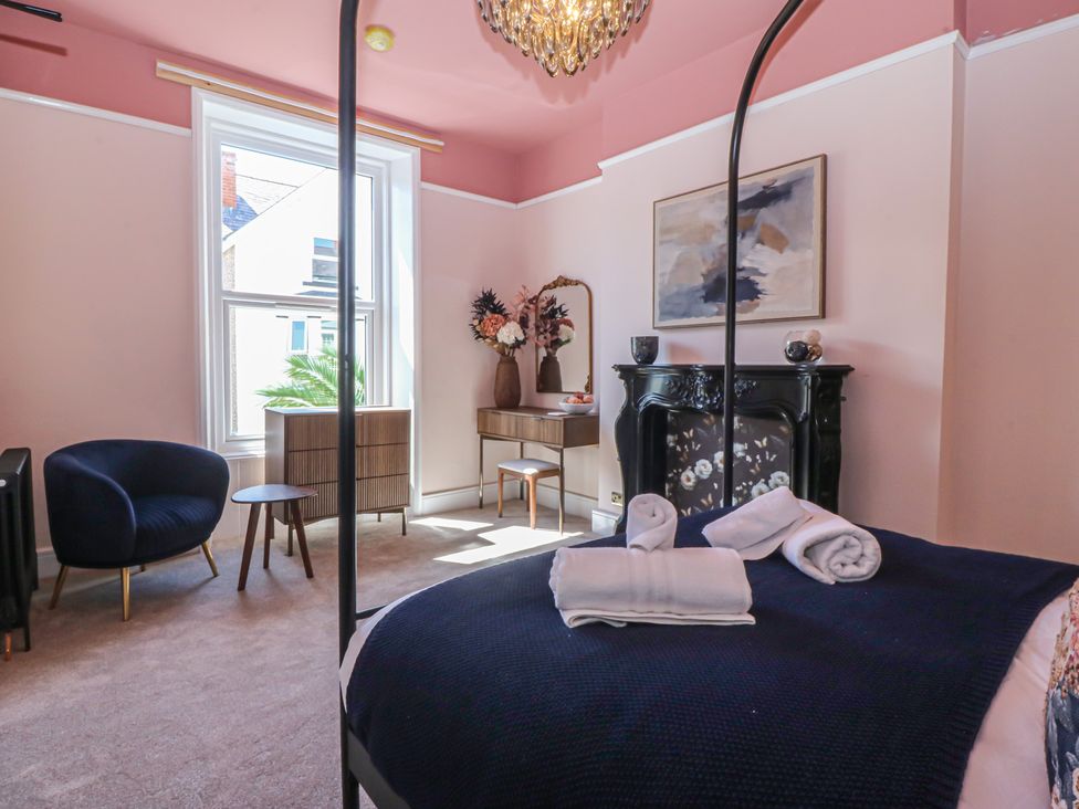 A bedroom with a bed and furniture at Fox House in Llandudno