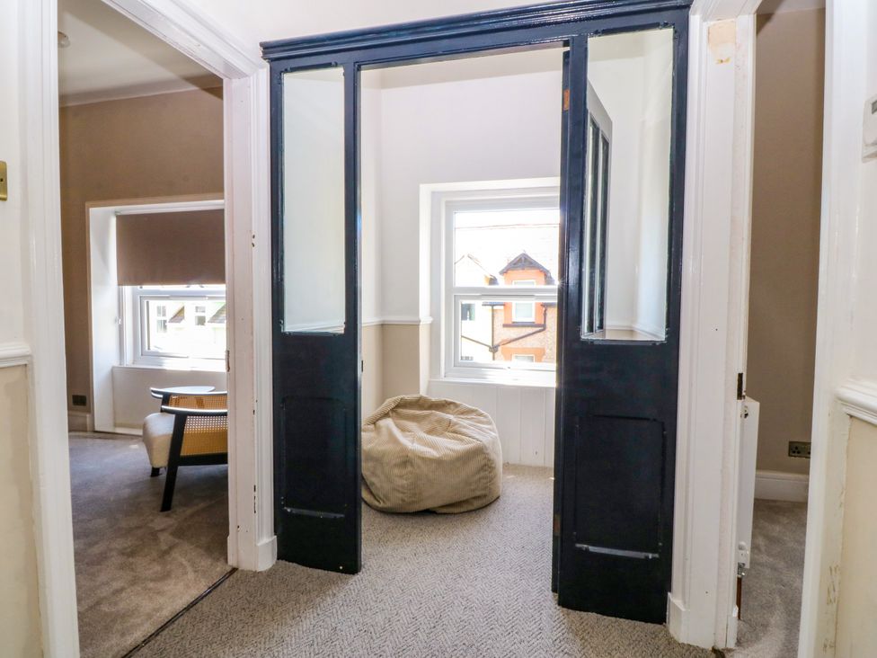 A hallway with a bean bag and a chair at Fox House in Llandudno