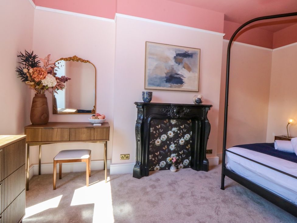 A bedroom with a bed and decorative elements at Fox House in Llandudno