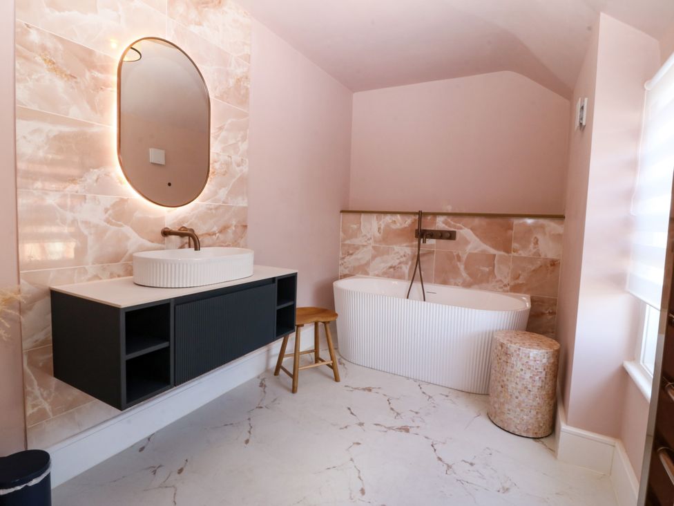 A bathroom with a sink and bathtub at Fox House in Llandudno