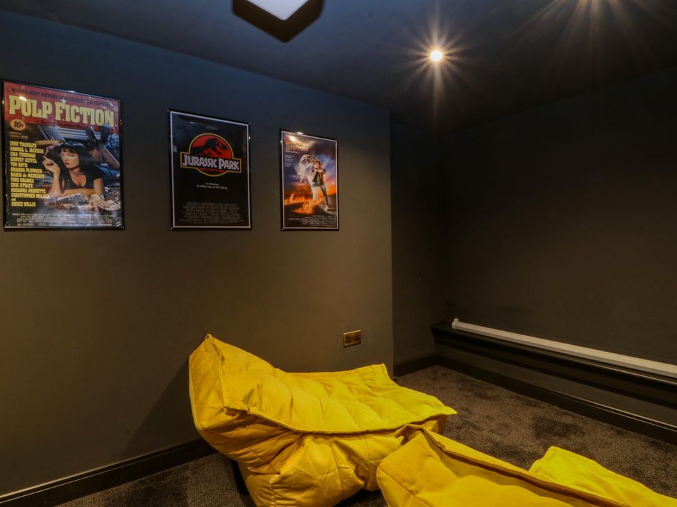 A media room with posters and bean bags at Fox House in Llandudno