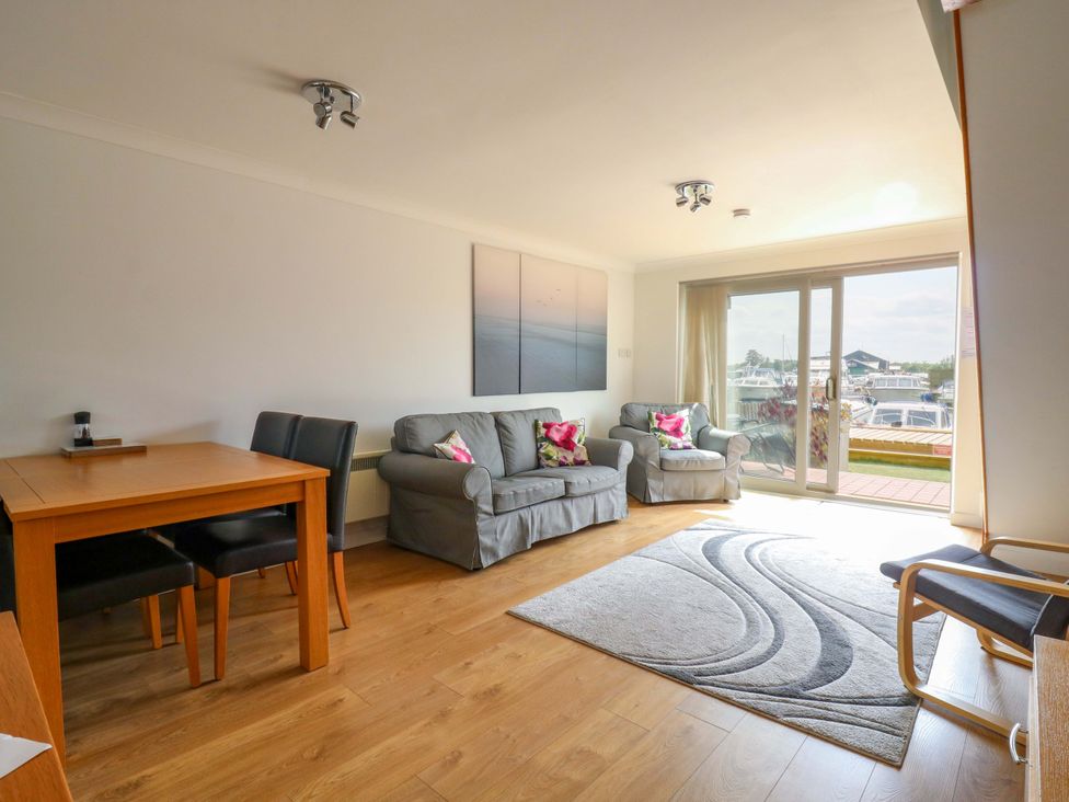 A living room with a sofa and dining table at Kingsmere in Norwich