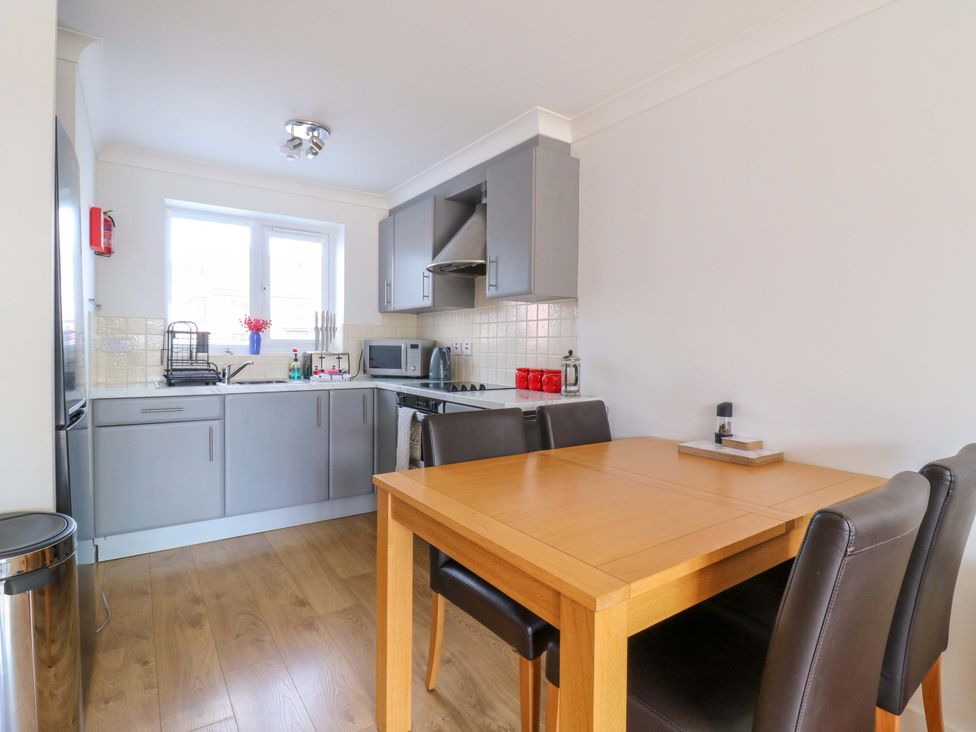A kitchen with a table and chairs at Kingsmere in Norwich