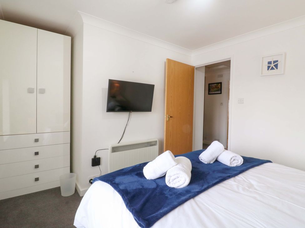 A bedroom with a bed and television at Kingsmere in Norwich