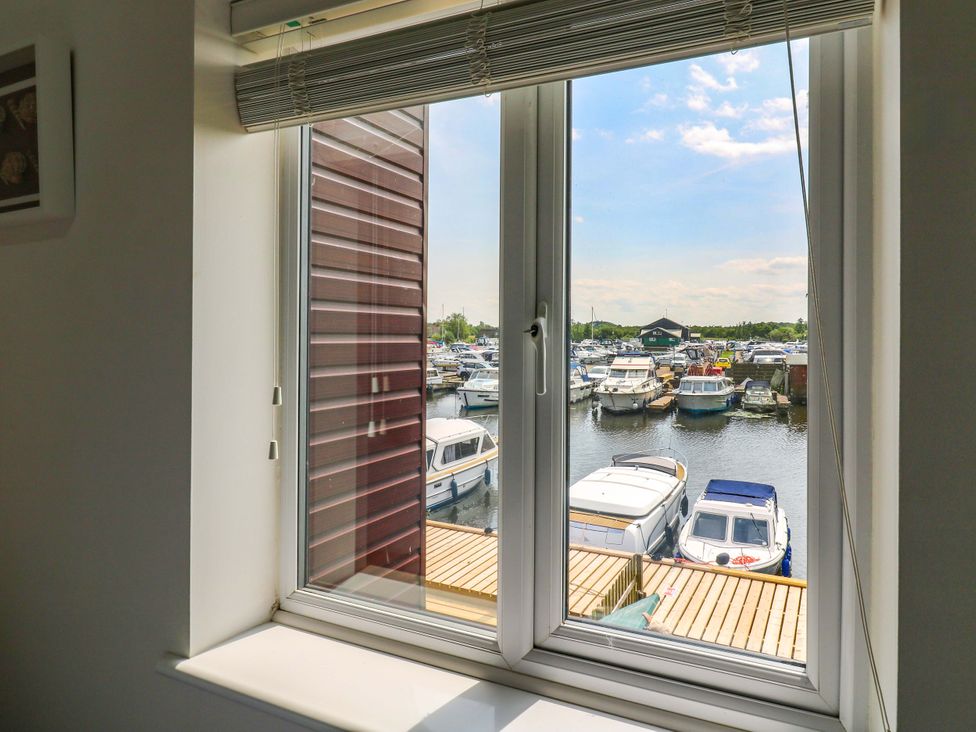 A view of boats on water from a window at Kingsmere in Norwich