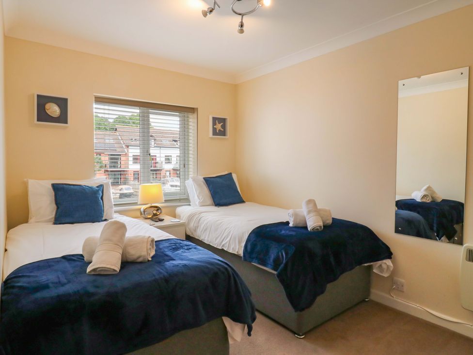 A bedroom with two beds and a window at Kingsmere in Norwich