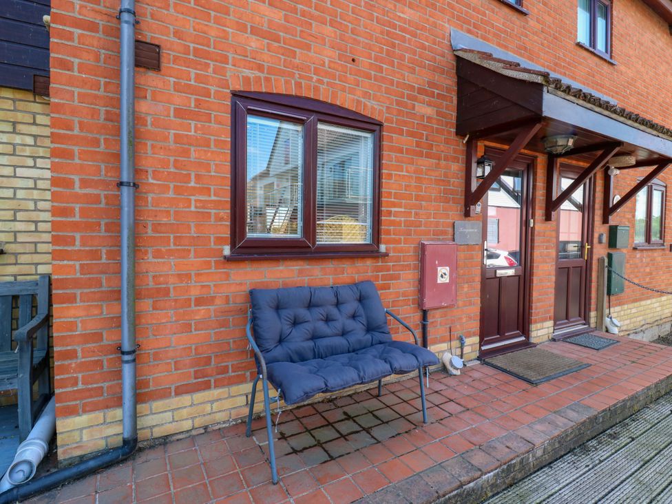 An entrance area with a bench and door at Kingsmere in Norwich
