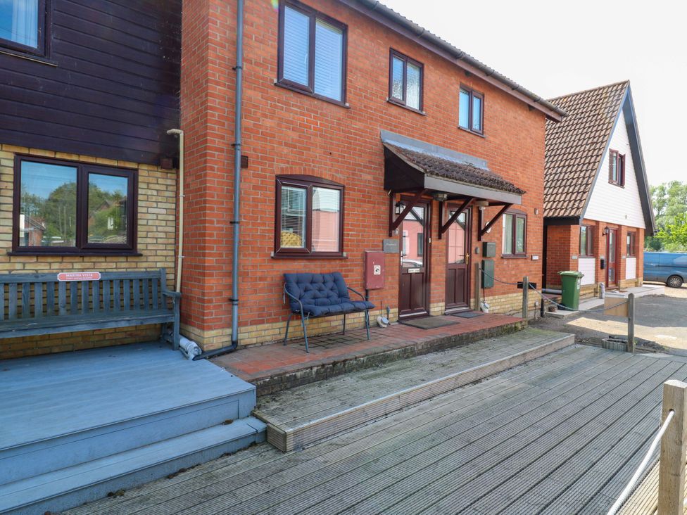 A building entrance with a bench and door at Kingsmere in Norwich