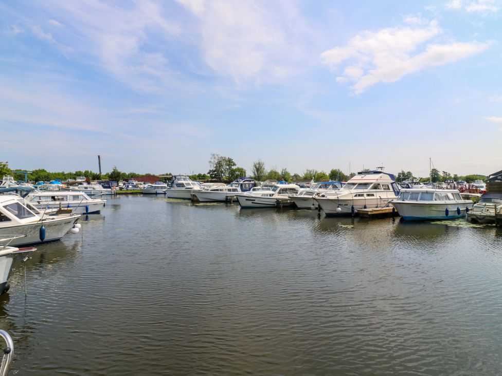 Boats moored at a marina with calm water at Kingsmere in Norwich