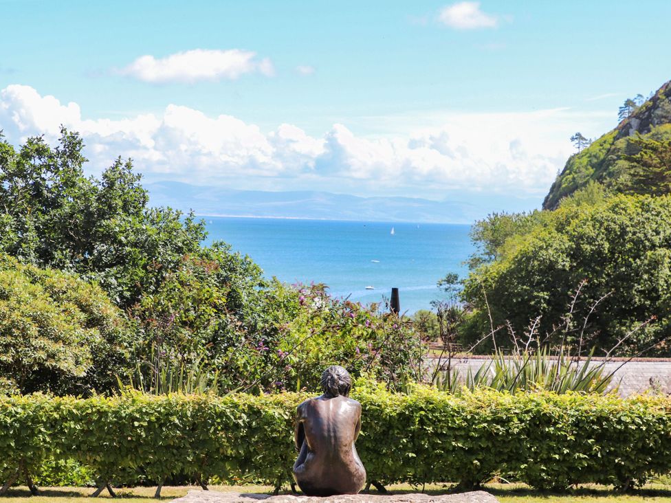 A sculpture viewed from behind overlooking the sea at 3 Glyn Y Mor Llanbedrog
