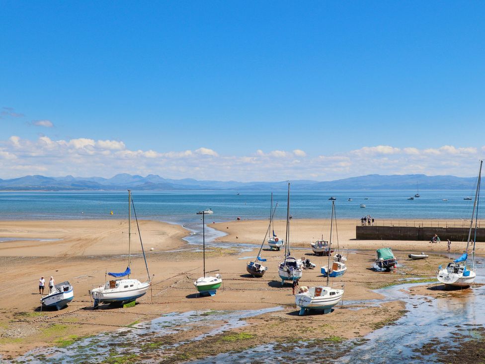Beach with sailboats on the shore and people walking at 3 Glyn Y Mor Llanbedrog