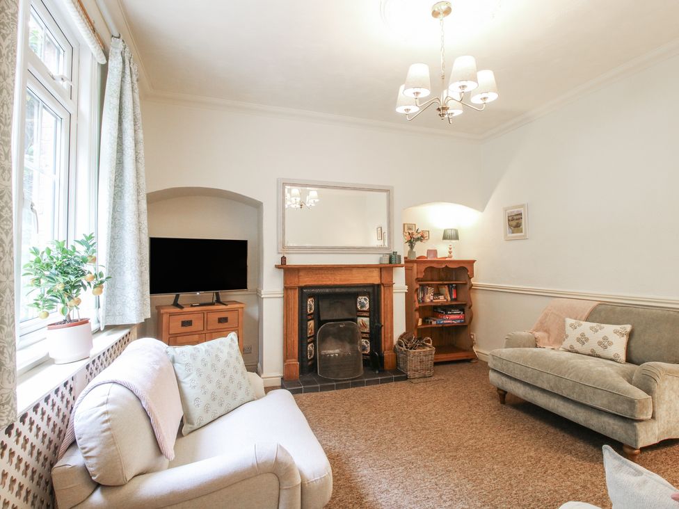 A living room with a television and a fireplace at 2 Aqueduct Cottages Chirk Bank near Chirk