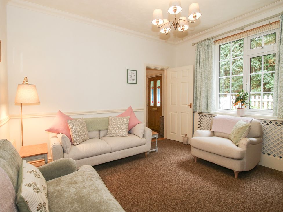 A living room with two sofas and a plant at 2 Aqueduct Cottages Chirk Bank near Chirk
