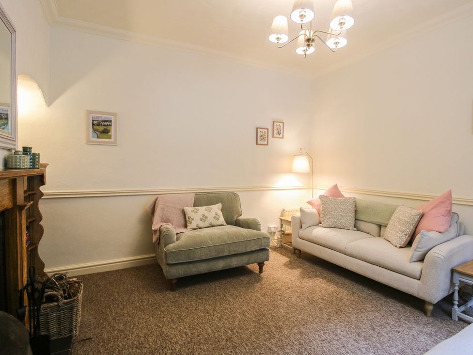 A living room with a sofa and armchair at 2 Aqueduct Cottages Chirk Bank near Chirk