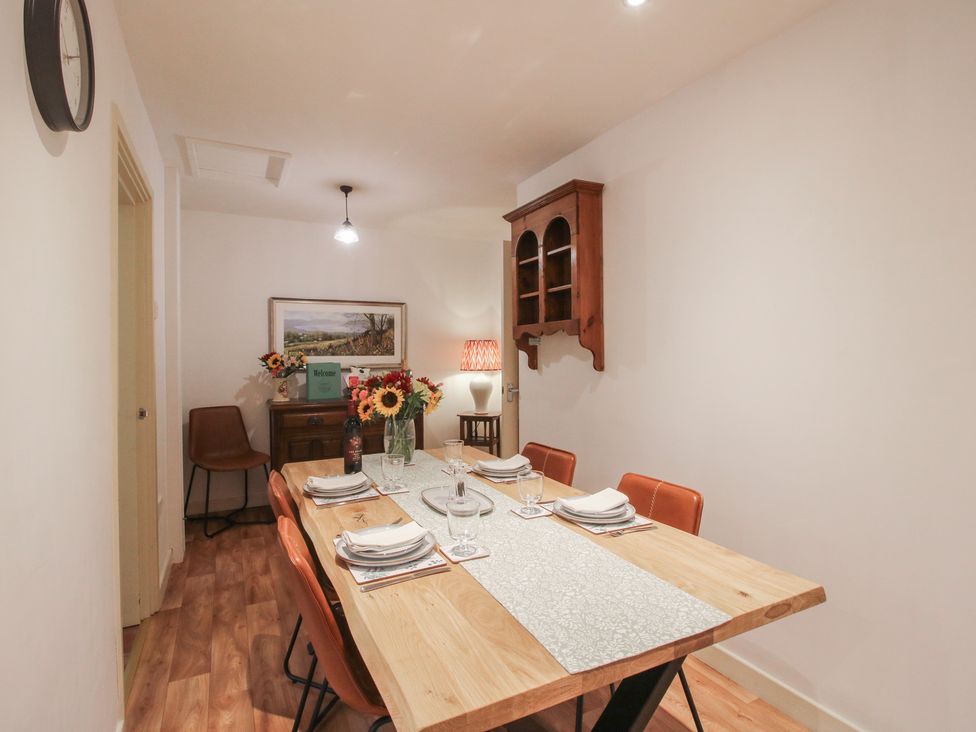 A dining room with a table set for meals at 2 Aqueduct Cottages Chirk Bank near Chirk