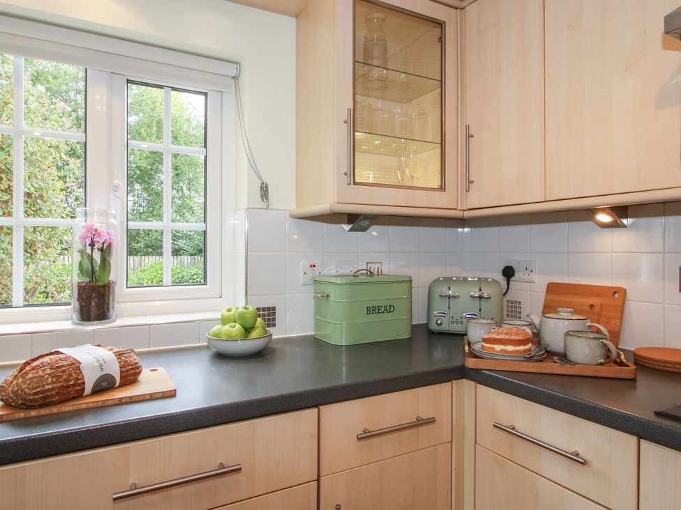 A kitchen with a countertop, window, and various kitchen items at 2 Aqueduct Cottages, Chirk Bank near Chirk