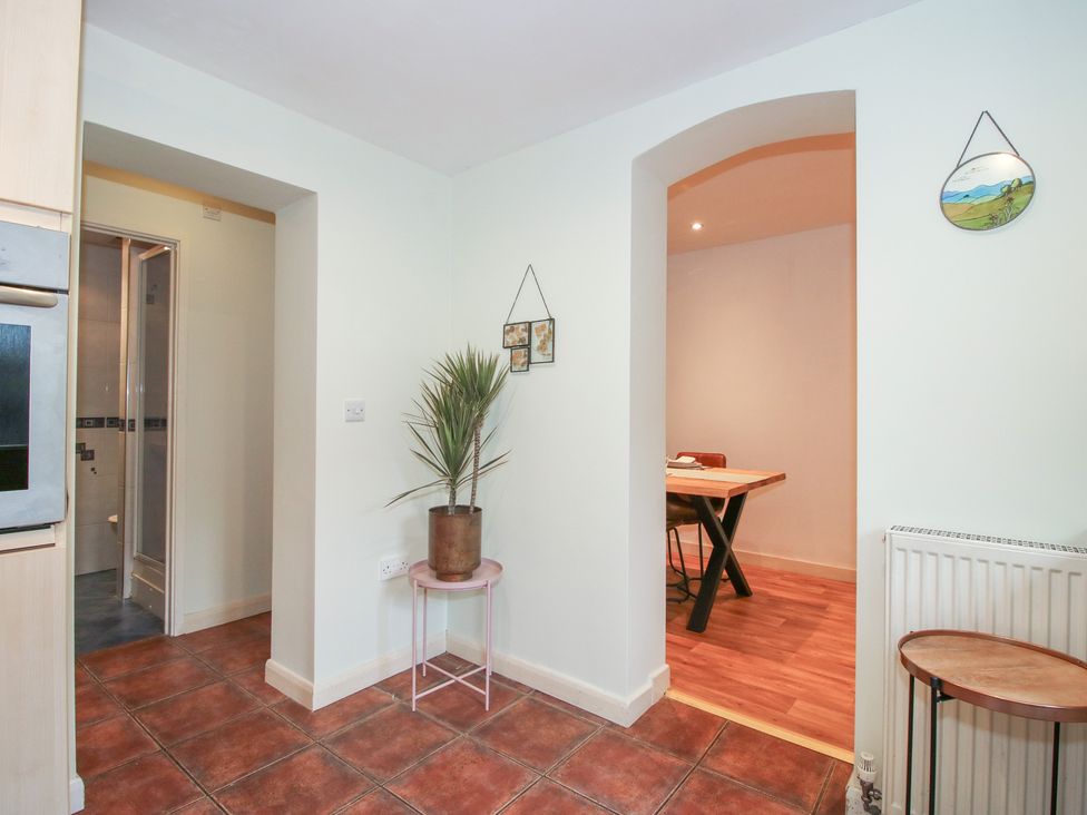A kitchen with a plant and a dining area at 2 Aqueduct Cottages Chirk Bank near Chirk