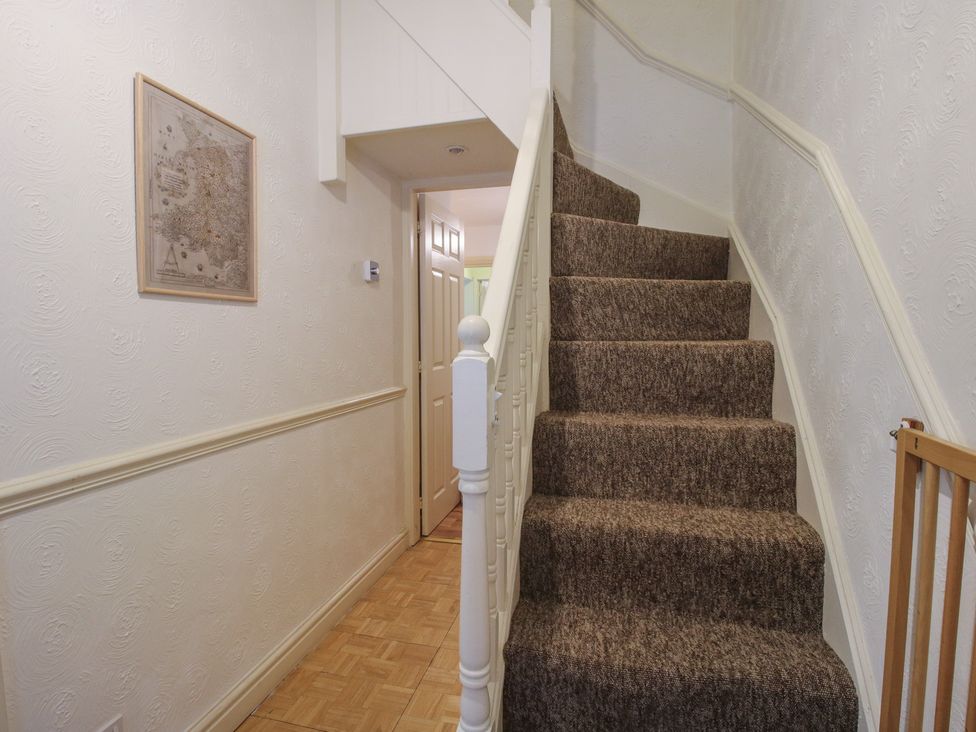 A hallway with stairs and a framed picture at 2 Aqueduct Cottages Chirk Bank near Chirk
