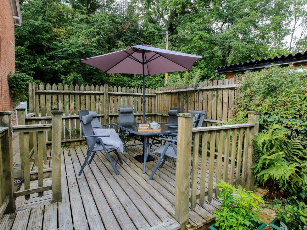 An outdoor seating area with a table and chairs at 2 Aqueduct Cottages Chirk Bank near Chirk