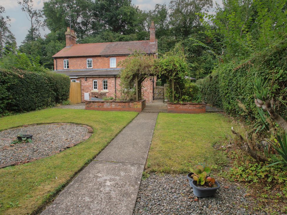 A garden with a pathway leading to a house at 2 Aqueduct Cottages Chirk Bank near Chirk